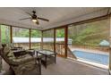 Relaxing screened porch with comfortable seating, offering serene views of the backyard and pool at 3653 Range Rd, Stem, NC 27581