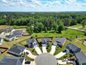 An aerial view shows the layout of homes on a cul-de-sac with lush green surroundings and a dense forest backdrop at 45 Iris Dr, Youngsville, NC 27596