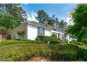 Beautifully maintained home exterior featuring lush landscaping and a cozy bench at 4830 North Hills, Raleigh, NC 27612