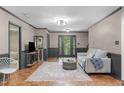 Bright living room with hardwood floors, modern lighting, and neutral decor with easy access to entryway at 603 Gentry Ln, Hillsborough, NC 27278