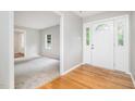 Inviting foyer with hardwood floors transitioning to carpet in the adjacent room at 606 Chalice St, Durham, NC 27705