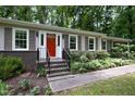 Close-up of the home's entrance with a bright red door and decorative landscaping at 606 Chalice St, Durham, NC 27705