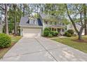 Eye-level view of the home's facade, front porch, and driveway on a sunny day at 640 St Vincent Dr, Holly Springs, NC 27540