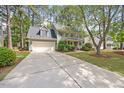 Attractive two-story home with attached garage, front porch, long driveway, and mature trees at 640 St Vincent Dr, Holly Springs, NC 27540