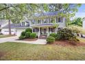 Inviting two-story home with a cozy front porch, attached garage, and well-maintained landscaping at 640 St Vincent Dr, Holly Springs, NC 27540