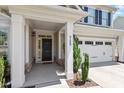 Inviting entrance with a covered porch, stone accents, and an attached two-car garage at 713 Apalachia Lake Dr, Fuquay Varina, NC 27526