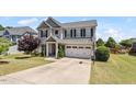 Attractive two-story home with a basketball hoop, manicured lawn, and an attached two-car garage at 713 Apalachia Lake Dr, Fuquay Varina, NC 27526