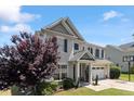 Well-maintained home with a landscaped front yard, two-car garage, and classic architectural details at 713 Apalachia Lake Dr, Fuquay Varina, NC 27526