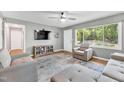 Bright living room with hardwood floors, a gray sofa, and a large window at 774 Salem Church Rd, Sanford, NC 27330