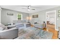 Cozy living room featuring hardwood floors and comfortable gray seating arrangement at 774 Salem Church Rd, Sanford, NC 27330