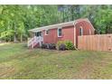 Brick home with a white railing leading to the entrance and a wooden fence at 774 Salem Church Rd, Sanford, NC 27330