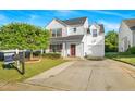 Attractive two-story home with an attached garage, manicured lawn, and 'For Sale' sign at 1022 Early Rise St St, Raleigh, NC 27610