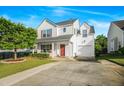 Charming two-story home with a well-manicured lawn, attached garage, and red front door at 1022 Early Rise St St, Raleigh, NC 27610