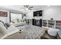 Inviting living room with fireplace, TV, ceiling fan, and white couches at 1022 Early Rise St St, Raleigh, NC 27610