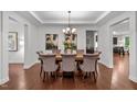 This dining room features a wooden table set for eight with elegant upholstered chairs at 109 Highland Mist Cir, Apex, NC 27539