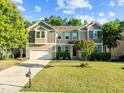 Charming two-story home featuring a well-manicured lawn, attached two-car garage, and traditional architectural details at 109 Highland Mist Cir, Apex, NC 27539