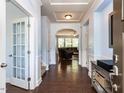 Elegant foyer with hardwood floors, arched doorway, and open view to the living area at 112 Victorian Oaks Dr, Durham, NC 27713