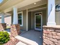 Welcoming front porch with stone accents, providing a charming entrance to the home at 112 Victorian Oaks Dr, Durham, NC 27713