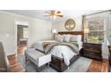 Comfortable bedroom with a king bed, hardwood floors, and ensuite bathroom access at 1199 Cesar Ct, Graham, NC 27253