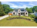 Exterior view of a landscaped two-story home with a manicured lawn at 1209 Briar Patch Ln, Raleigh, NC 27615