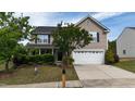 Charming two-story home with a well-manicured lawn and inviting front porch at 126 Thimbleweed Ln, Lillington, NC 27546