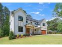 Charming exterior showcasing the home's architectural details, including a covered porch and wood accents at 1301 Doylin Dr, Cary, NC 27511