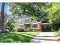 Charming two-story home with lush landscaping, brick accents and a convenient carport at 1324 Swallow Dr, Raleigh, NC 27606