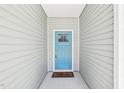 A welcoming, light blue front door provides curb appeal at 15 Nottingham Pl, Smithfield, NC 27577