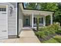 Close-up of the front door, framed by white columns and landscaping at 15 Nottingham Pl, Smithfield, NC 27577