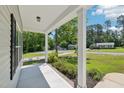 Covered porch with view of the street and neighboring houses at 15 Nottingham Pl, Smithfield, NC 27577