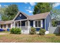 Charming blue home featuring a cozy front porch and white trim details at 1508 Malta Ave, Raleigh, NC 27610