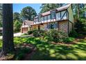 Charming two-story home with brick and Tudor-style accents, an attached garage, and well-manicured landscaping at 1604 Westbridge Ct, Raleigh, NC 27606