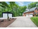 Back exterior boasts a detached two-car garage, a basketball court, and lots of space for parking at 168 E Deer, Apex, NC 27523