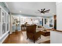 Open living room provides hardwood floors and views to the kitchen with a decorative tree feature at 168 E Deer, Apex, NC 27523