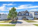 Inviting townhome showcasing a well-maintained lawn and driveway on a sunny day at 172 Wellons Creek Dr, Garner, NC 27529
