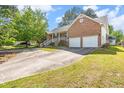 Wide driveway and brick home with front porch, perfect for comfortable living and easy access at 1732 Bobwhite Ln, Rocky Mount, NC 27804