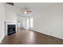 Bright living room with hardwood floors, a ceiling fan, and a cozy fireplace at 1910 Falls Landing Dr, Raleigh, NC 27614