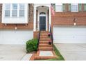 Welcoming front entrance with brick steps, black door, and neat landscaping at 2506 Blooming St, Raleigh, NC 27612