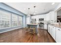Bright kitchen with white cabinets, stainless steel appliances, and a center island at 2506 Blooming St, Raleigh, NC 27612