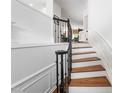 Elegant staircase with dark railing and decorative trim at 2506 Blooming St, Raleigh, NC 27612