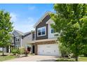 Charming two-story home featuring a stone-accented facade, two-car garage, and a beautifully landscaped front yard at 2513 Magnolia Tree Ln, Durham, NC 27703