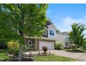 Charming two-story home featuring a stone-accented facade, two-car garage, and a beautifully landscaped front yard at 2513 Magnolia Tree Ln, Durham, NC 27703