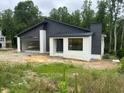 Striking modern home design with a combination of brick and dark siding accents at 269 Deer Tail Ln # 44, Fuquay Varina, NC 27526