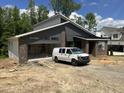 A new construction modern home with attached garage and attractive gray board and batten at 269 Deer Tail Ln # 44, Fuquay Varina, NC 27526