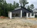 Contemporary home showcasing unique architecture with an open garage and stylish exterior finishes at 269 Deer Tail Ln # 44, Fuquay Varina, NC 27526