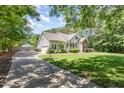 Inviting two-story home with a long driveway, attached garage, and well-manicured lawn and landscaping at 2833 Praire View Pt, Wendell, NC 27591