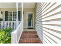 Close-up of the brick-step front porch with white siding and green foliage accents at 2833 Praire View Pt, Wendell, NC 27591