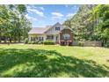 Charming two-story home with a well-maintained lawn and complemented by mature trees at 2833 Praire View Pt, Wendell, NC 27591