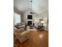 Cozy living room with a fireplace, vaulted ceiling and ample seating at 2833 Praire View Pt, Wendell, NC 27591