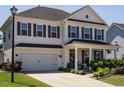 Inviting two-story home with a covered front porch, showcasing curb appeal at 2909 Thurman Dairy Loop, Wake Forest, NC 27587